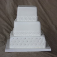 White Square Quilted Wedding 8" 6" 4" squares quilted and sugar pearls added to intersections. Fondant ribbon boarders also quilted.