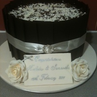 Cheesecake Wedding Cake Double decker new york baked cheesecake with dark chocolate panels, white and dark chocolate shavings and gumpaste roses.