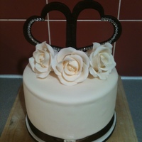 6" Choc Mudcake Cutting Cake A cutting cake for a wedding cupcake tower. Gumpaste roses with a choc fondant heart topper that I made and attached diamantes.