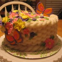 Flower Basket This was my final cake for my Wilton 2 course. Oval with buttercream basketweave and royal icing flowers. Color Flow butterflies.