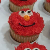 Elmo Face Cupcakes Elmo face cupcakes made to accompany a Elmo sheet cake. Used Wilton tip 233 for the fur/hair. Icing: wilton class buttercream