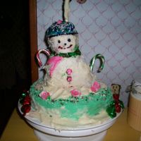 Snowman Coconut cake made with butter Cream Frosting. The grandchildren ha a lot of fun with this one.