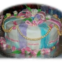 Christmas 2006 Four layer tortCoconut cake, coconut filling and Butter cream frosting.Covered with Fondant. Hand made Rose's and gold dust beads.Just...