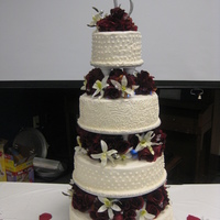 Wedding Cake Tiers separated by silk flowers and LED lights