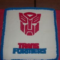 Transformers I made this cake for my son's 7th birthday. Buttercream iced with piping gel transfer method used for the Transformersemblem and logo...