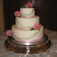 Wedding Cake Fresh flowers. Cascades are ribbon.