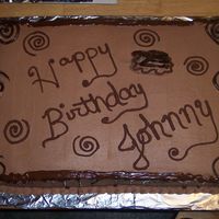 Lots Of Choc. a big choc and vanilla cake with choc. bc and choc swirls and writing. A big cake for a big ol' boy!!!!!