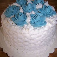 Small Wedding Cake A 6" wedding cake done in a simple basketweave with blue roses covering the top.