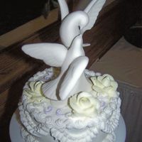 Buttercream Wedding Cake (Top Layer) The top of the wedding cake I did today. The otehr picture didn't really show the detail very well so I thought I'd send this as...