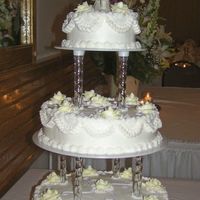 Buttercream Wedding Cake A wedding cake I did today. It is all buttercream with pale yellow roses and lilac accents. I enjoyed making this.