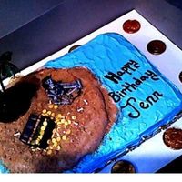 Pirate Treasure Cake Not very cool or difficult...but it's what the customer ordered! Just a buttercream ocean, graham cracker crumbs for sand, chocolate...