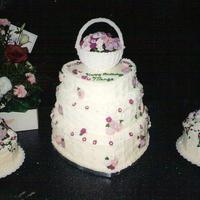 A Rose Garden This was a special cake for a very dear friend of ours on her 50th birthday. She still has the basket of flowers on the center cake.