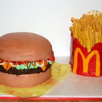 Burger And Fries I made this for a friends baby shower.The fry cake is carrrot cake and all fondant .The burger is yellow and chocolate cake with...