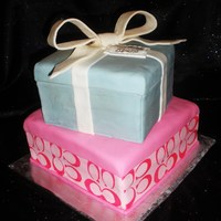 Coach Gift Box Cake This is a 2 tier butter cake covered in fondant. The top tier is a gift box in the Tiffany Box style, the bottom tier is a Coach Gift Box....