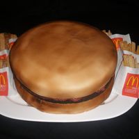 Hamburger Cake With Sugar Cookie Fries The bun is a 14" butter cake covered in buttercream and then fondant. Then airbrushed. The Hamburger is a brownie that I baked in the...