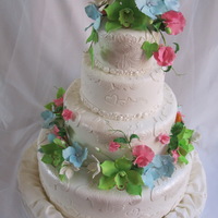 Wedding Cake Gum paste :cymbidium orchids , sweet peas, gardenias, blue hydrangeas