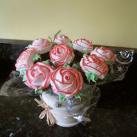 Cupcake Bouquet Blueberry mini muffins with icing. My fisrt time making roses... you can tell haha