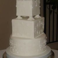 White Wedding Inspired by Martha Steward. Pipping in royal icing. Little flowers are gumpaste. Flowers on top of cake are real. I have added addition...