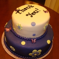 Monty's Cake Top tier has 3 layers of vanilla almond with raspberry filling. Bottom tier is marble with Bavarian cream filling. The cake is covered in...