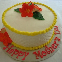 Mother's Day Flower Basket 3 layers of vanilla almond cake filled with Bavarian cream and covered in butter cream frosting. The flowers were made from gum paste.