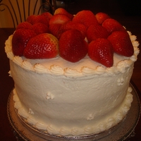 Strawberry Layer 3 Layer cake covered with butter cream and topped with fresh strawberries.