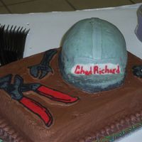 Chad's Groom's Cake Chocolate cake with cherry filling, chocolate buttercream frosting. Hard hat made from cake and covered with bc. tools are FBCT.