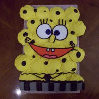 Spongebob Spongebob it is! This is like a jigsaw puzzle made of 24 cupcakes. the face is made of fun foam and the dots are black chocolate...