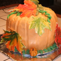 Pumpkin Shaped Cake Bottom is chocolate, chocolate chip and the top is spice cake. Covered in buttercream with white chocolate maple leaves.