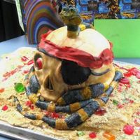 Skull And Snake Hand painted fondant skull and snake, buttercream/cookie crumbs and candy sand.