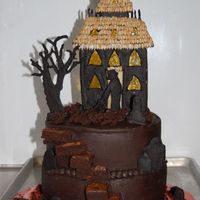 Scare Watcher Cake Two tiered cake with chocolate buttercream icing, and cookie dough for the tombstones, house, tree and man. Sunflower seeds for the...