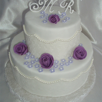 Purple Roses And Pearls Hand rolled MMF pearls with lustre dust. Purple roses, also MMF. Initials are piped with RI and attached with wire in the back.