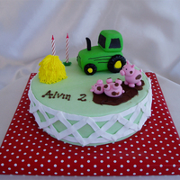 Farm Tractor This was for a little boy turning 2. Tractors are not easy to do, let me tell you... but I guess it turned out ok. The pigs were more fun...