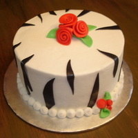 Zebra/whimsical Roses Iced in buttercream with fondant accessories.