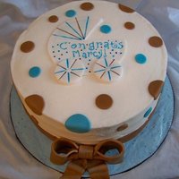 Dots Shower Cake White chocolate cake w/ strawberry filling, covered in buttercream and mmf decorations.