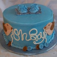 Clothesline Cake Yellow cake with chocolate buttercream filling.Covered in buttercream and mmf decor, gumpaste shoes.