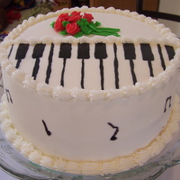 Piano Recital White cake iced with vanilla butter cream. Piano keys and roses are fondant.