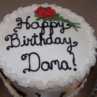 Happy Birthday White cake iced with vanilla butter cream icing and fondant roses.