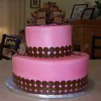 Pink Dotty Baby Shower White cake iced with vanilla butter cream icing. Dots and bow are made from fondant/ gum paste
