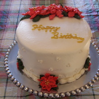 Christmas Birthday White cake with vanilla butter cream icing. Everything is butter cream except for the edible pearls on the side and the glitter gel. I will...