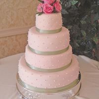 Light Pink This was light pink fondant, green ribbon, pearls, and dark pink roses....wasn't sure I was liking the color scheme so well (as the...