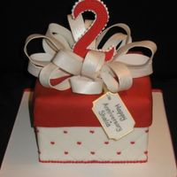 Red And White Anniversary Cake Square fondant covered cake with fondant loop bow. I made the 2 out of 50/50 paste and thenpiped dots on top. Gift tag also made out of...