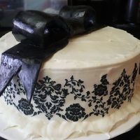Birthday Cake For Andrea #3 This cake is a dense lemon cake and topped and filled with a lemon curd buttercream. Decorations included a black fondant bow and a...