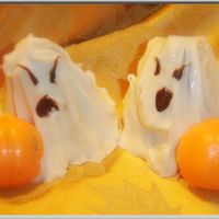 Halloween Ghost And Pumpkin Cake Balls Devils Food cake crumbled, mixed with bc frosting and a bit of raspberry preserves. Shaped into blobs for Ghosts and coated with melted...