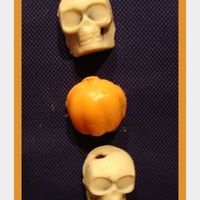 Halloween Skulls And Pumpkin Cake Balls Devils food cake crumbled with bc icing and raspb. preserves. Formed both in silicone molds (made for ice cubes). White Chocolate melted...