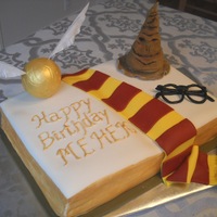 Harry Potter Theme Cake Open book cake covered with fondant and fondant accents.