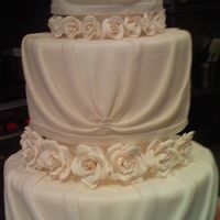 My Wedding Cake There was a forth tier underneath but it wasn't done when I took the picture. All the roses were rolled by hand and done petal by...