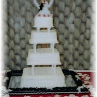 Square Wedding 14, 12, 8, 6in tiers, all buttercream...buttercake. Made some really pretty red buttercream roses to go in the corners...but the bride...