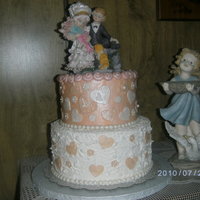 Sweetheart Wedding Dummy cake covered in fondant with fondant and gumpaste decorations. Stucco technique on the lower tier.