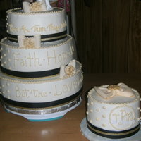 Cream, Gold And Black Wedding 4 tiers, SugarShack buttercream and method, 6',8',10' and 12' butter and chocolate cakes. Gumpaste bows and medallions...