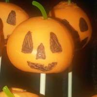 Pumpkin Cake Pops I used WASC scraps and mixed with buttercream, dipped in chocolate and used a piece of licorice string as his stem. My edible marker wouldn...